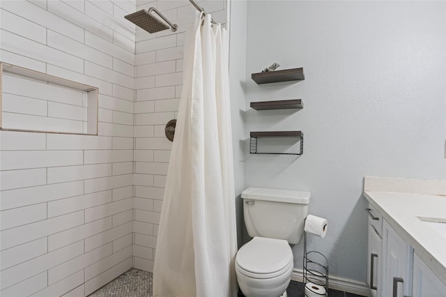 full bathroom featuring a stall shower, vanity, and toilet