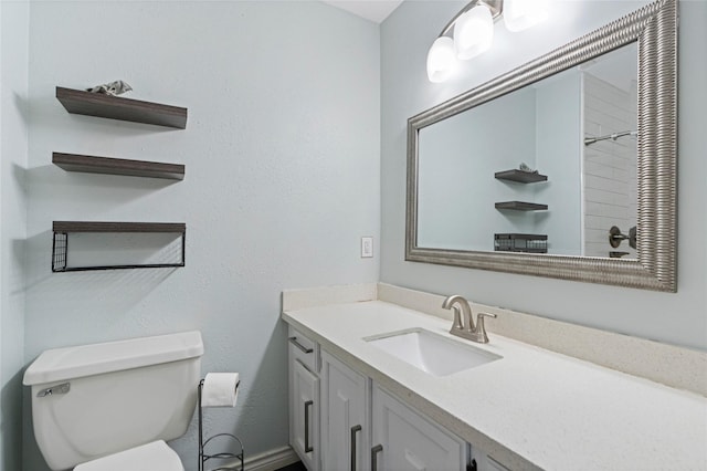 bathroom with toilet and vanity