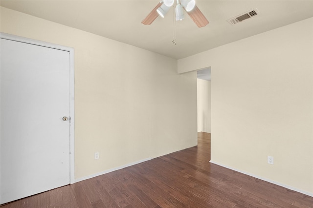 spare room with a ceiling fan, baseboards, visible vents, and wood finished floors