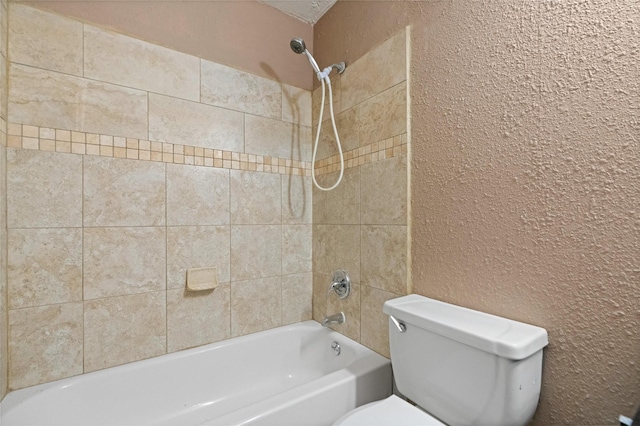 bathroom featuring toilet, bathtub / shower combination, and a textured wall