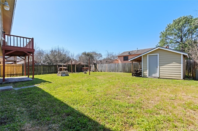 view of yard with an outbuilding, a fenced backyard, and a storage unit