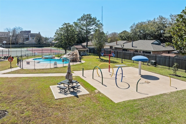 view of home's community with playground community, a yard, a swimming pool, and fence