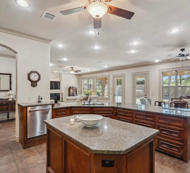 901 Longmire Rd Unit 17, Conroe, TX 77304 - kitchen featuring ceiling fan, dishwasher, a kitchen island, recessed lighting, and ornamental molding
