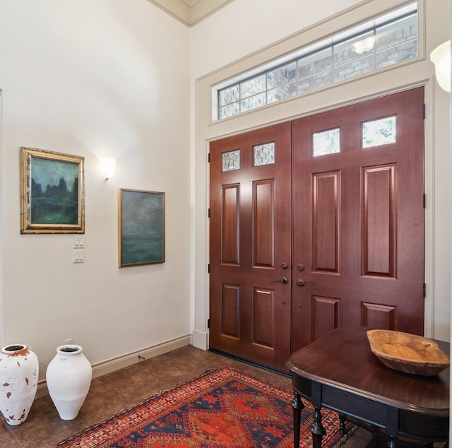 901 Longmire Rd Unit 17, Conroe, TX 77304 - foyer entrance featuring baseboards, a high ceiling, dark tile patterned floors, and plenty of natural light