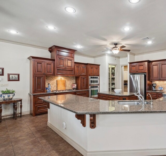 901 Longmire Rd Unit 17, Conroe, TX 77304 - kitchen with appliances with stainless steel finishes, a sink, a center island, a ceiling fan, and recessed lighting