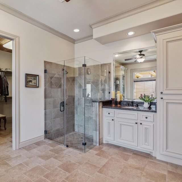 901 Longmire Rd Unit 17, Conroe, TX 77304 - full bathroom with ceiling fan, vanity, a stall shower, stone finish floors, and baseboards