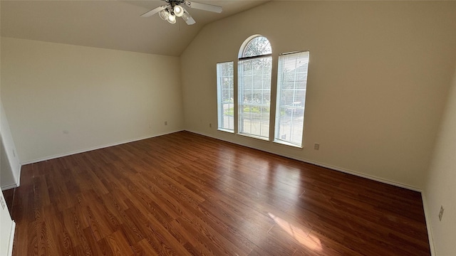 spare room featuring ceiling fan, baseboards, wood finished floors, and lofted ceiling