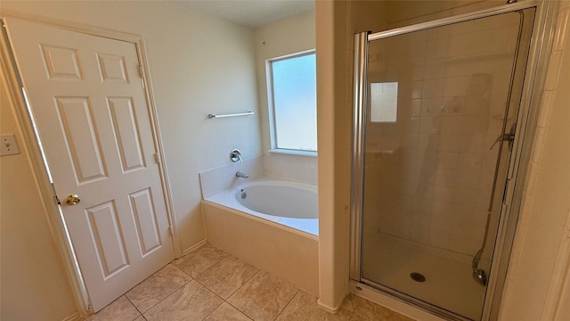 full bathroom featuring a garden tub, tile patterned flooring, and a shower stall