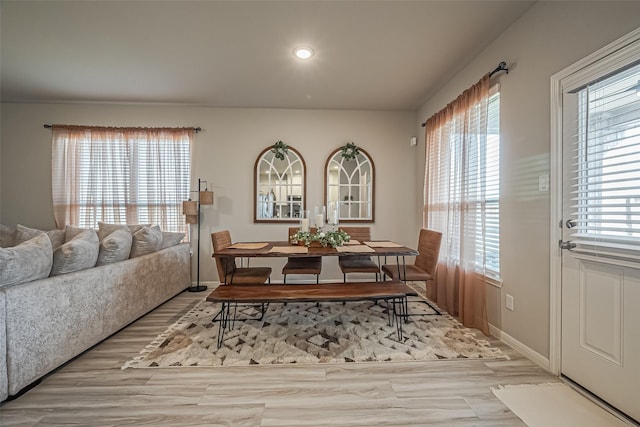 dining room featuring recessed lighting, a healthy amount of sunlight, baseboards, and wood finished floors