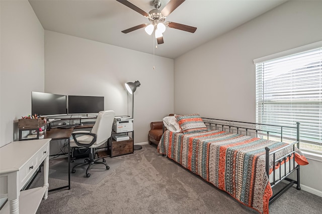 carpeted bedroom with ceiling fan and baseboards