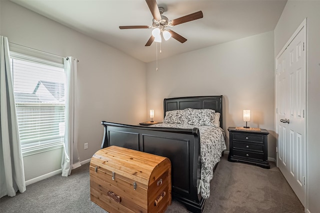 carpeted bedroom with ceiling fan and baseboards