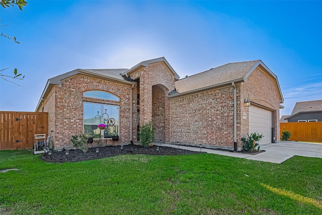 ranch-style house featuring concrete driveway, brick siding, fence, and a front lawn