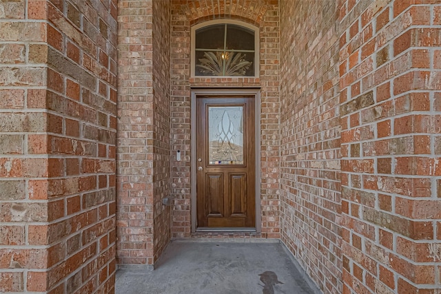 property entrance featuring brick siding