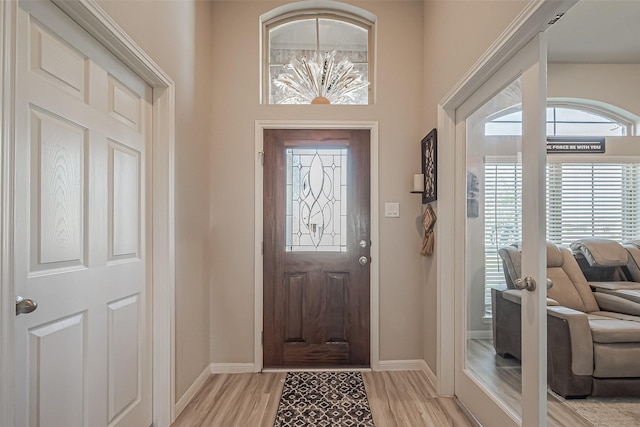 entrance foyer with light wood-type flooring and baseboards