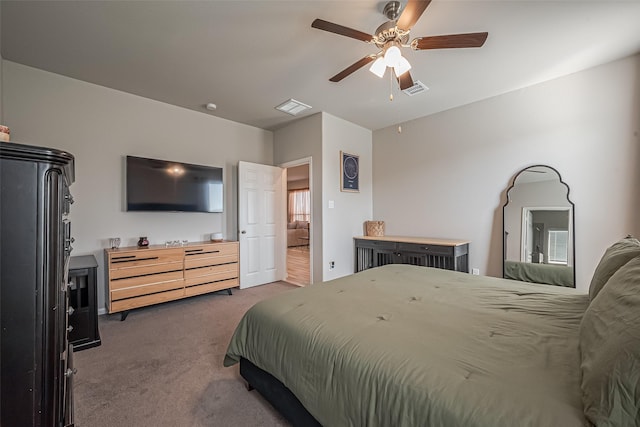 bedroom with carpet, visible vents, and ceiling fan