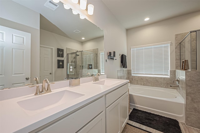 full bathroom featuring a bath, a stall shower, a sink, and visible vents