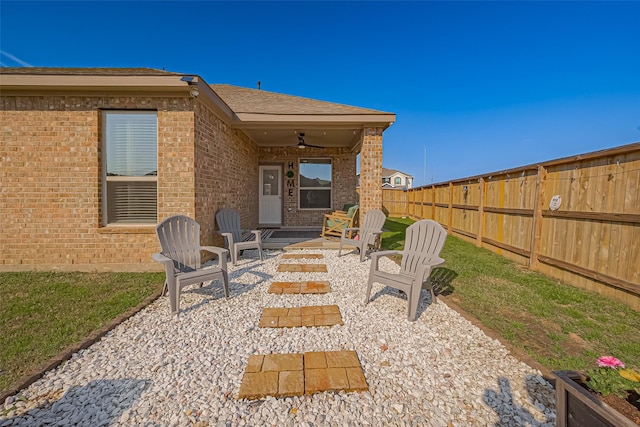 view of patio / terrace with fence and a ceiling fan