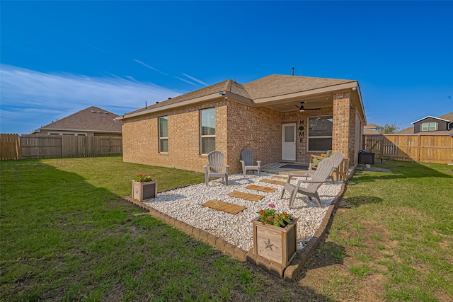 back of house featuring a patio, a fenced backyard, brick siding, a ceiling fan, and a lawn