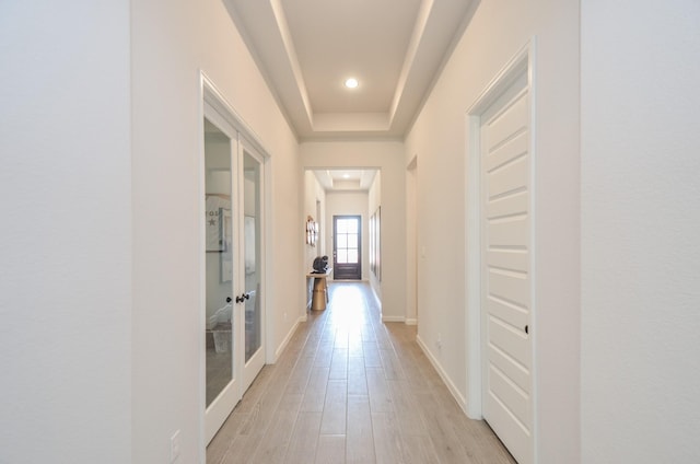 10711 Kingston Spring Dr, Missouri City, TX 77459 - corridor featuring french doors, light wood finished floors, recessed lighting, baseboards, and a tray ceiling
