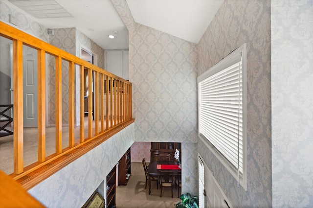 stairway featuring a fireplace and wallpapered walls