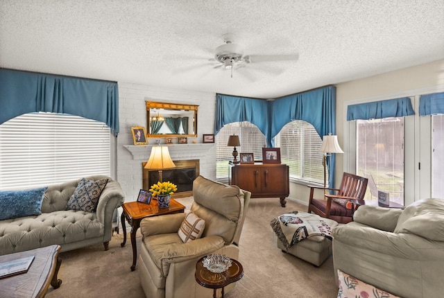 carpeted living area featuring a textured ceiling, a brick fireplace, and a ceiling fan