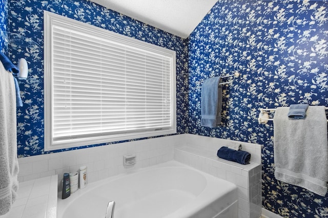 full bath with a bath, a textured ceiling, and wallpapered walls