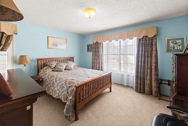 carpeted bedroom featuring a textured ceiling