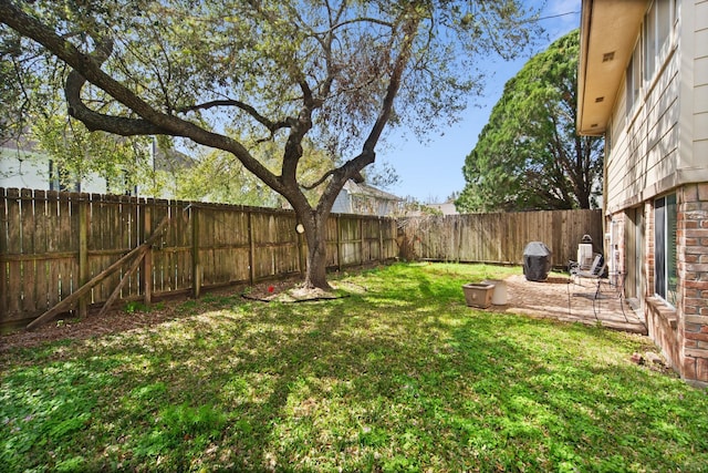 view of yard with a fenced backyard and a patio area