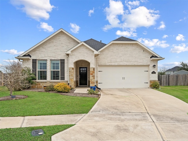 view of front of house featuring concrete driveway, an attached garage, fence, and a front lawn