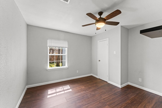 unfurnished bedroom with wood finished floors, a ceiling fan, and baseboards