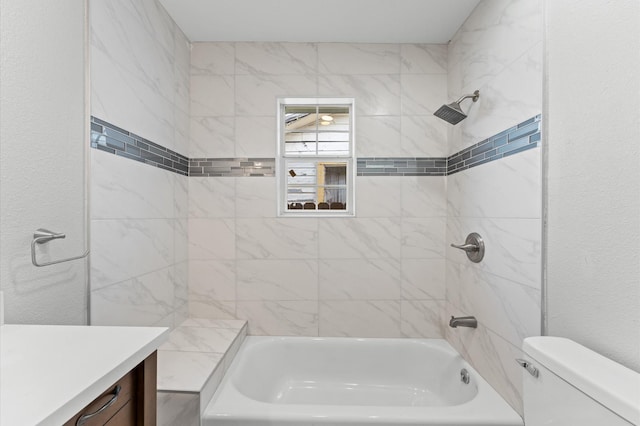 bathroom with shower / bathtub combination, a textured wall, vanity, and toilet