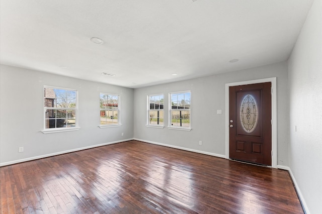 foyer featuring visible vents, hardwood / wood-style flooring, and baseboards