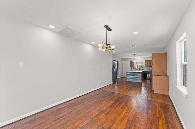 unfurnished living room featuring dark wood-style floors, recessed lighting, visible vents, and baseboards