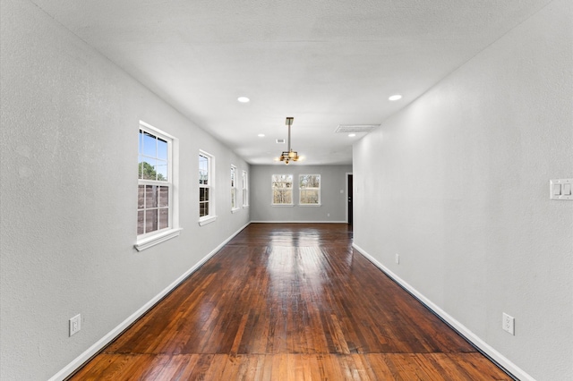 interior space with hardwood / wood-style flooring, visible vents, baseboards, and recessed lighting