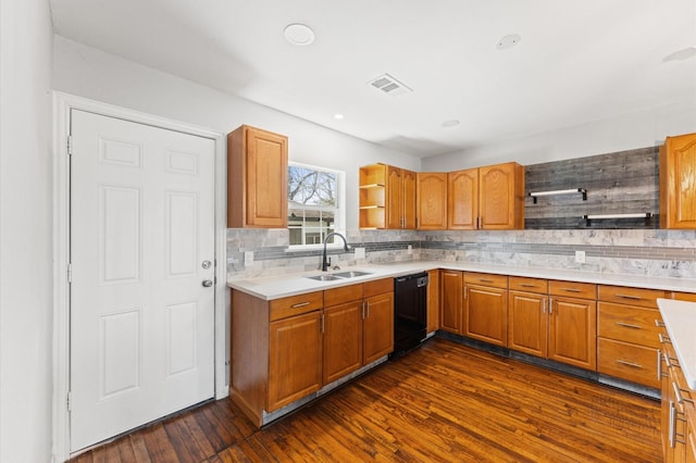 kitchen featuring black dishwasher, dark wood-style flooring, light countertops, open shelves, and a sink