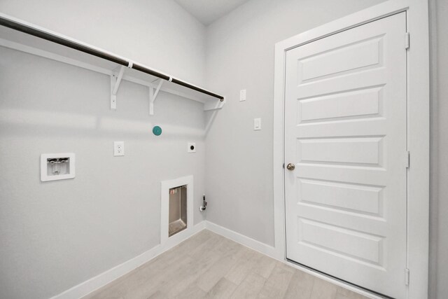 11926 Maple Oak Dr, Houston, TX 77066 - laundry room with hookup for an electric dryer, hookup for a gas dryer, washer hookup, and light wood-type flooring