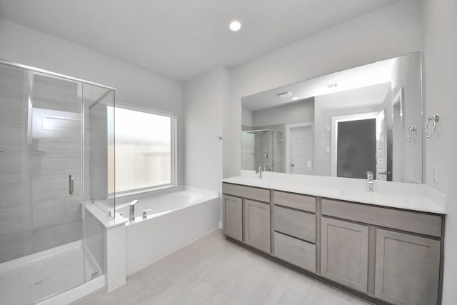 11926 Maple Oak Dr, Houston, TX 77066 - full bathroom featuring a stall shower, double vanity, a garden tub, and recessed lighting