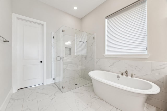 bathroom with marble finish floor, a soaking tub, a marble finish shower, and recessed lighting