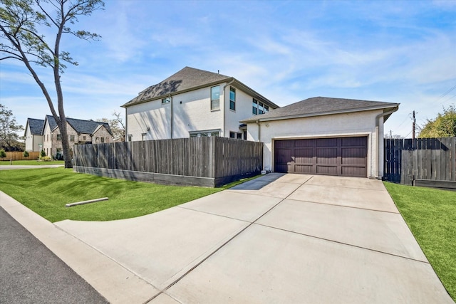 view of home's exterior with stucco siding, concrete driveway, a lawn, fence, and a garage