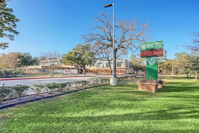 surrounding community with fence and a lawn