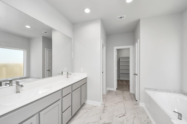 bathroom with recessed lighting, visible vents, marble finish floor, and a sink