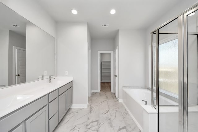 bathroom featuring visible vents, baseboards, a garden tub, recessed lighting, and marble finish floor