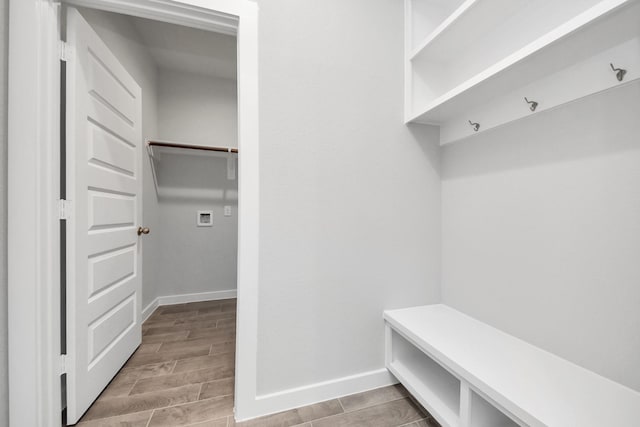 mudroom featuring baseboards and wood finish floors