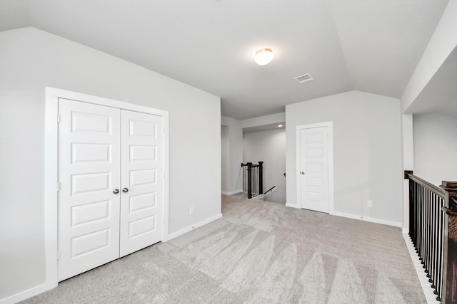 bonus room with vaulted ceiling, carpet, visible vents, and baseboards