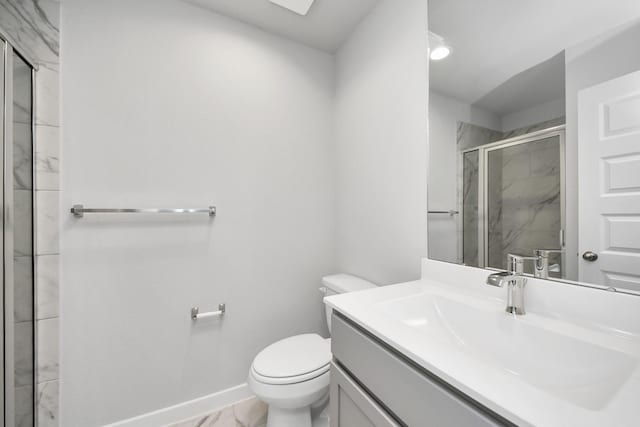 bathroom featuring a marble finish shower, baseboards, toilet, marble finish floor, and vanity