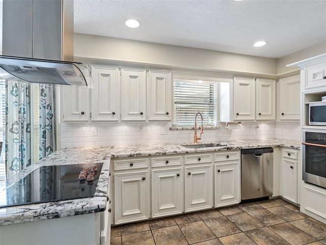 kitchen featuring a sink, white cabinets, appliances with stainless steel finishes, backsplash, and island exhaust hood