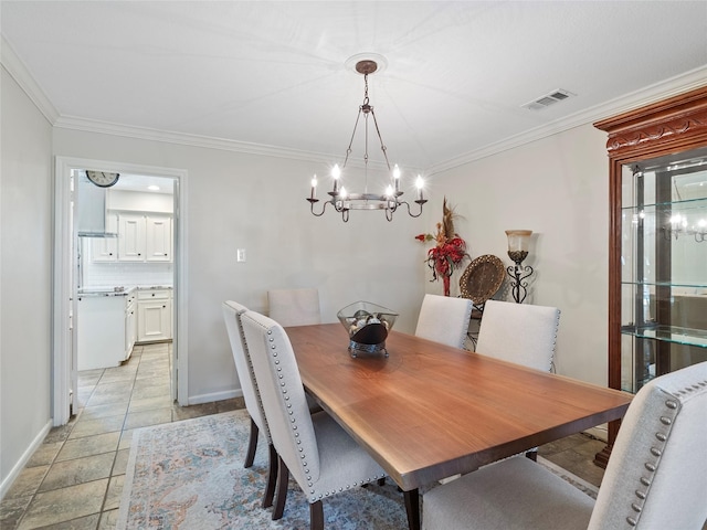 dining area featuring baseboards, visible vents, a chandelier, and ornamental molding