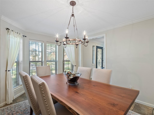 dining area featuring a chandelier, crown molding, and baseboards