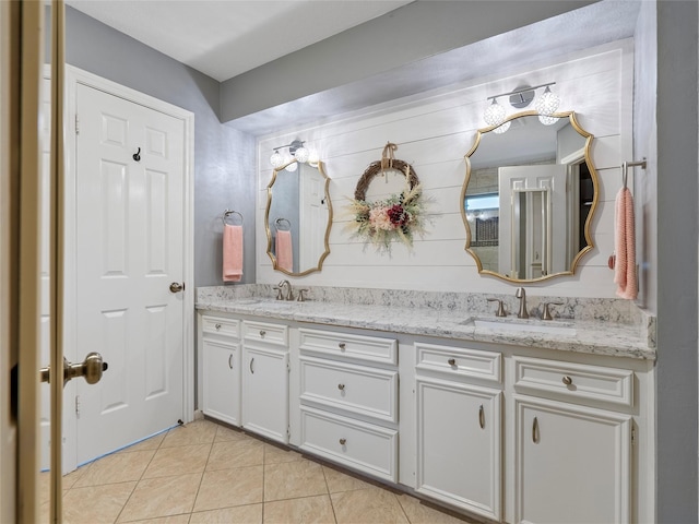 bathroom featuring double vanity, tile patterned flooring, and a sink