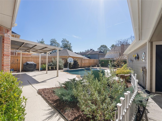 view of swimming pool with grilling area, a patio area, a fenced backyard, and a fenced in pool